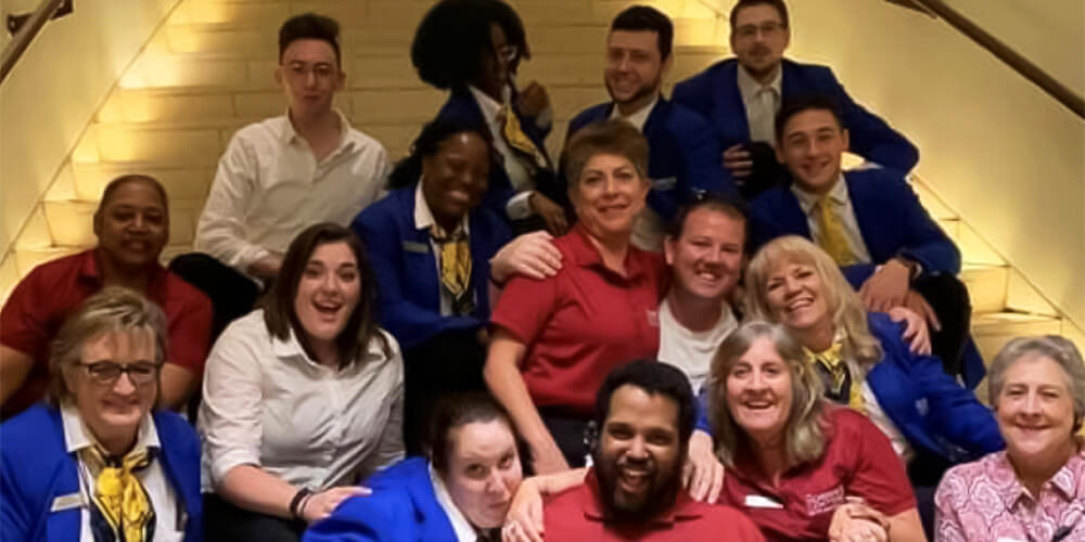 Group of house staff crowded together on stairs in various poses