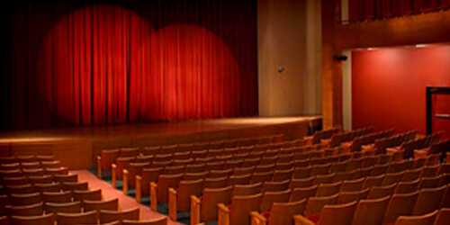 View of Zilkha Hall from the back of the theater, looking at the seating and the stage