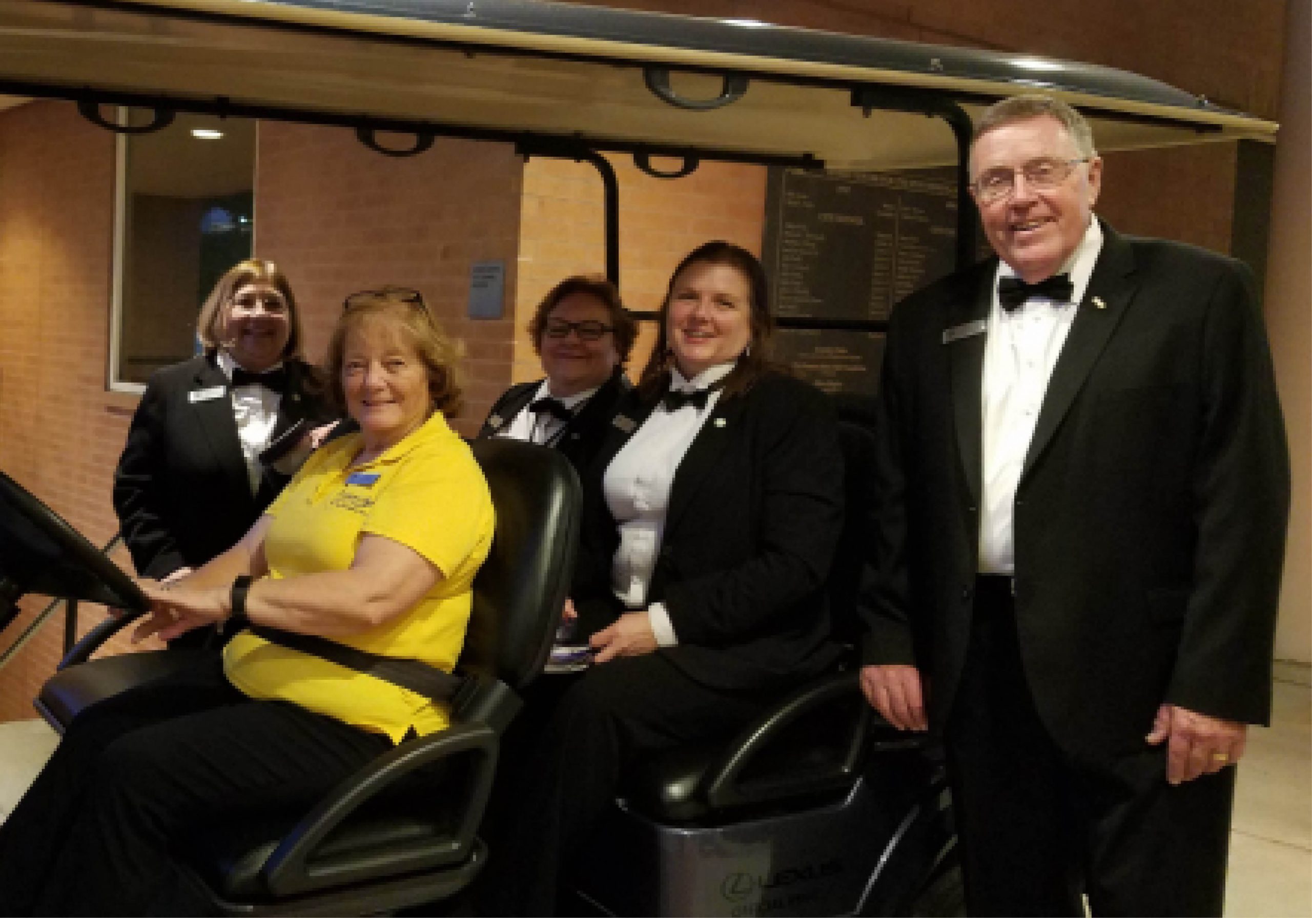 Access Team and Hobby Center volunteers on a golf cart