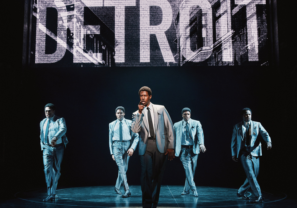 The cast of Ain't Too Proud on stage performing with "DETROIT" written above